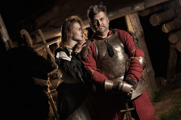 Fototapeta na wymiar Medieval peasant woman is embracing her knight.