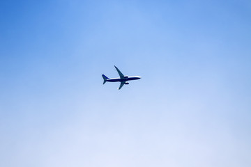 Fototapeta na wymiar Airplane over clear blue sky