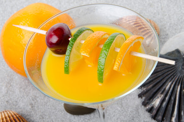 Orange cocktail on a sand background