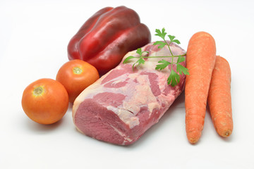 Bottom round roast raw with vegetables to prepare a recipe