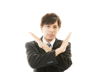 禁止の意思表示をするビジネスマン