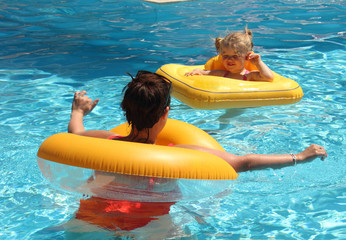Mother and daughter together in a swimming pool