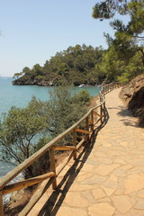 Fototapeta na wymiar A pathway with fencing along the coast at katranci bay, Turkey
