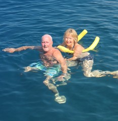 An english couple swimming in the sea while on vacation 2014 