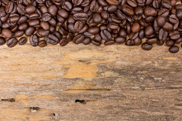 Coffee beans on wood background