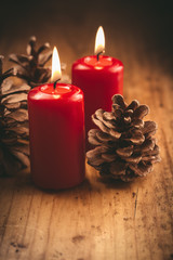Fototapeta na wymiar Christmas candles with pine cones