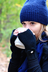 Girl drinking tea in the cold