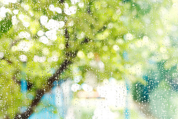 home window with raindrops after summer rain
