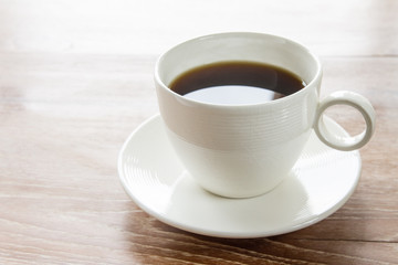 Cup of coffee on wooden table