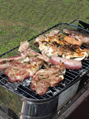 Barbecued steak and sausages on the grill