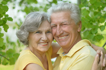 Retired couple smiling outdoors