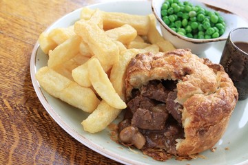 steak and mushroom pie with chips and peas