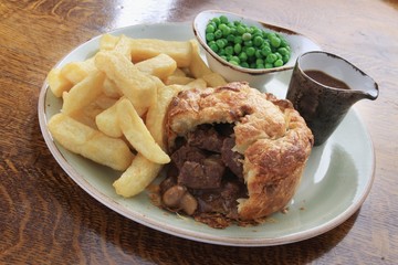 steak and mushroom pie with chips and peas