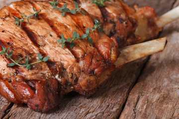two hot juicy pork steak with thyme macro on an old table