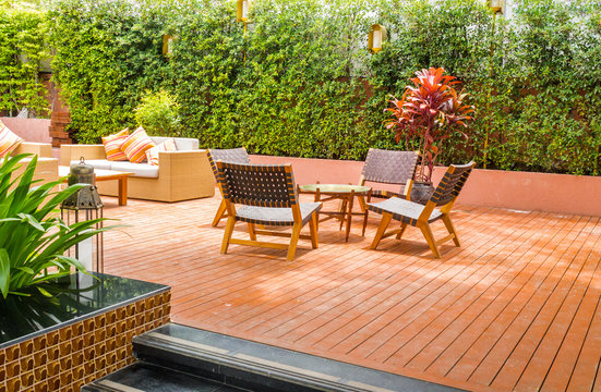 Tableset on terrace, tree frence background.