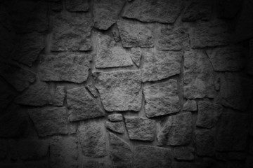 Black wall with textured stone blocks