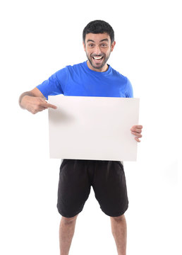 young attractive sport man holding blank billboard as copy space