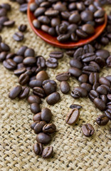 Coffee beans on wood spoon and Burlap Bag.