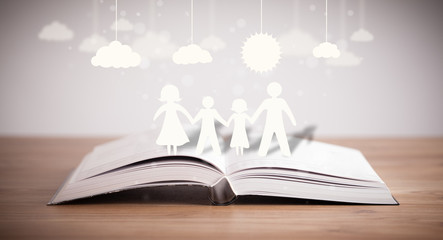 Cardboard figures of the family on opened book