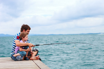 Father and son fishing together