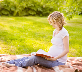 Pregnant woman reading a book