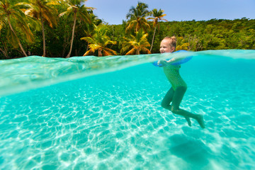 Little girl swimming in ocean