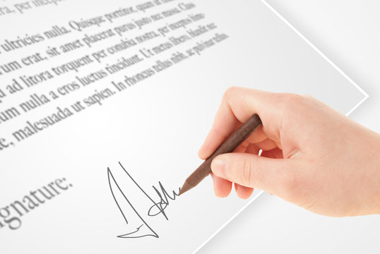 Hand writing personal signature on a paper form