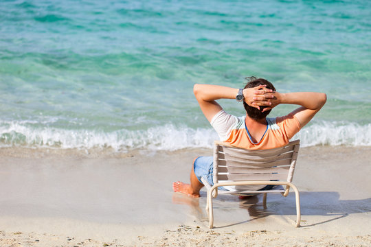 Man Relaxing At Beach