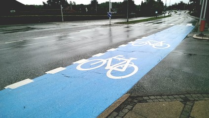 Empty blue bike lane in rain