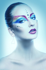 Sexy portrait of female with multicolor make up in cold tones