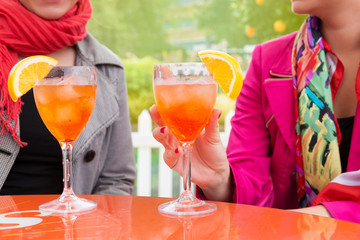 Attractive young women enjoying cocktails in an outdoor bar