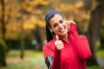 Successful female runner with earphones
