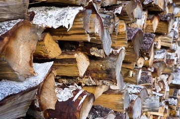 Closeup of woodpile with chunk of birch wood.