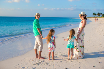 Naklejka premium Happy family of four on caribbean holiday vacation