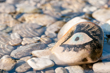 eye painted on a pebble stone