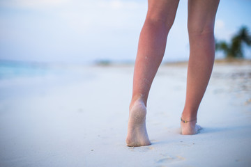 Close up of male legs on white sandy beach
