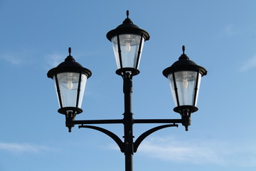 Fototapeta na wymiar A Stand of Three Vintage Style Street Lamps.