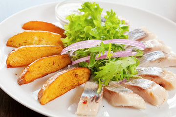 Fried potato with pickled herring