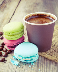macaroons and espresso coffee cup  on wooden rustic table