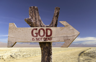 God Is Not Dead wooden sign with a street background