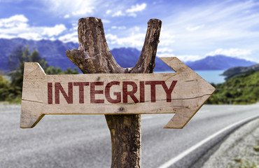Integrity wooden sign with a street background