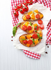 Tasty bruschetta with tomatoes, on table