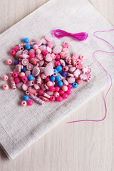 Different beads and lace on fabric on fabric background