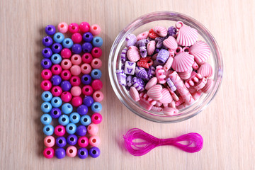 Multicoloured beads and lace stacked neatly on the table