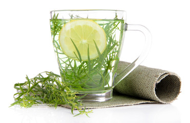Glass of estragon drink on napkin isolated on white