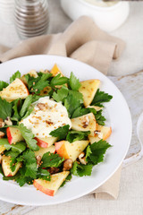 Green salad with apples, walnuts and cheese on light background