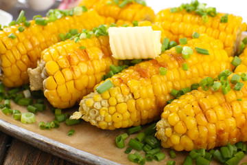 Grilled corn cobs on table, close-up