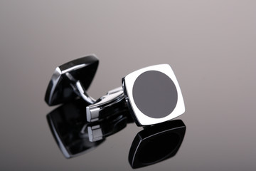 Pair of cuff links on dark grey background