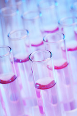 Test tubes with lilac liquid closeup