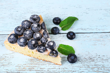 Tasty homemade pie with blueberries on wooden table